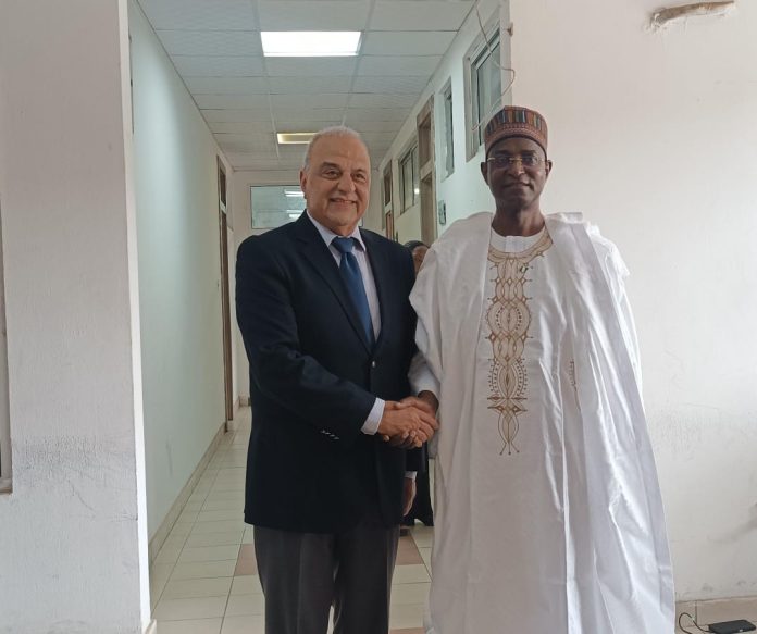 The Honourable Minister, Federal Ministry of Livestock Development Idi Mukhtar Maiha, in a handshake with the CEO of MCI Sante' Animale, Dr. Tadiaoui Omari Khalid, today in his office.