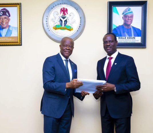 Former Minister of Finance and Coordinating Minister of the Economy Mr. Wale Edun handing over the baton of Office to Mr. Taiwo Oyedele Minister of Finance and Coordinating Minister of the Economy