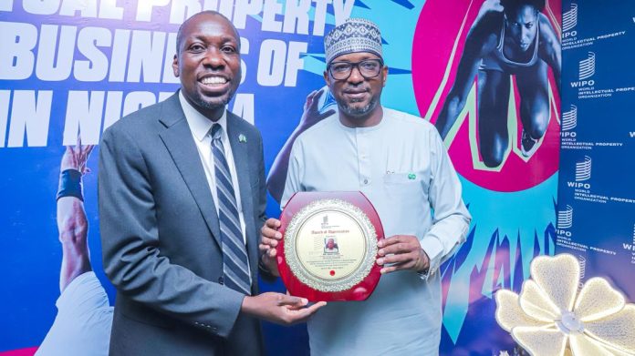 Director World Intellectual Property Organization (WIPO) Nigeria Office Dr. Moody Oluwatobilola presenting an award of appreciation to National Sports Commission Chairman Mallam Shehu Dikko
