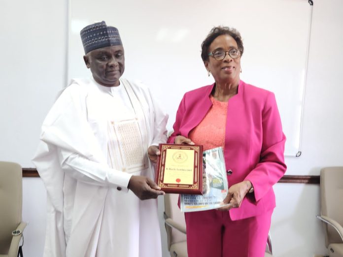 The Director-General/CEO of the Nigerian Technical Aid Corps (NTAC), Rt. Hon. Yusuf Buba Yakub, presenting a plaque and NTAC magazine to the Honourable Minister of Educational Transformation, Barbados, Hon. C. Sandra V. Husbands, M.P.