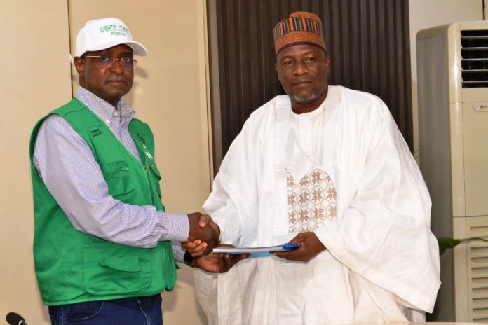 The Honourable Minister of Federal Ministry of Livestock Development Idi Mukhtar Maiha in an handshake with the National President of the National Association of Donkey Farmers in Nigeria, Alhaji Abubakar kagu.