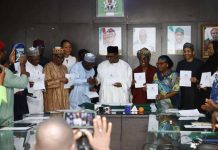 Professor Pate in handshake with the Registrar/CEO, Pharmacy Council of Nigeria, Pharm. Ibrahim Babashehu Ahmed FPSN during the launching of e-Pharmacy regulations, 2026; supported by other dignitaries at the event.