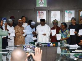 Professor Pate in handshake with the Registrar/CEO, Pharmacy Council of Nigeria, Pharm. Ibrahim Babashehu Ahmed FPSN during the launching of e-Pharmacy regulations, 2026; supported by other dignitaries at the event.