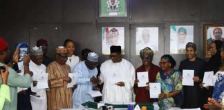 Professor Pate in handshake with the Registrar/CEO, Pharmacy Council of Nigeria, Pharm. Ibrahim Babashehu Ahmed FPSN during the launching of e-Pharmacy regulations, 2026; supported by other dignitaries at the event.