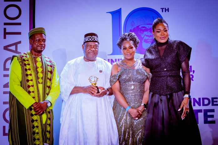 (2nd left) The representative of Mr. President and Secretary to the Government of the Federation, Sen. George Akume CON displaying the plague of the Presidential Award presented to President Tinubu by the Tunji Braithwaite Foundation in Abuja.