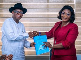 (R-L) The incoming Permanent Secretary, Political and Economic Affairs Office, Mrs. Bekearedebo Augusta Warrens taking over the official documents from the Director Overseeing the Political and Economic Affairs Office, Mr. Ifiok B. Abia on her assumption of office in OSGF.