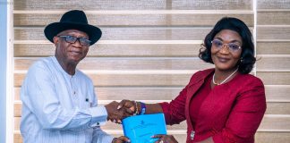 (R-L) The incoming Permanent Secretary, Political and Economic Affairs Office, Mrs. Bekearedebo Augusta Warrens taking over the official documents from the Director Overseeing the Political and Economic Affairs Office, Mr. Ifiok B. Abia on her assumption of office in OSGF.