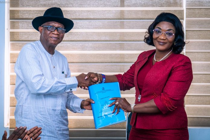 (R-L) The incoming Permanent Secretary, Political and Economic Affairs Office, Mrs. Bekearedebo Augusta Warrens taking over the official documents from the Director Overseeing the Political and Economic Affairs Office, Mr. Ifiok B. Abia on her assumption of office in OSGF.