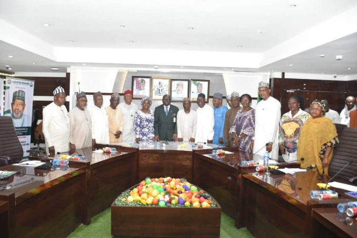 The Representative of the Minister of State for Agriculture and Food Security/ Permanent Secretary in the Ministry, Dr Marcus Olaniyi Ogunbiyi (C) and Members of the Ministerial Technical Committee on RH- CRRP.