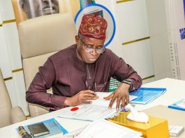 The Permanent Secretary, signing the contract aggrement