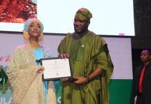 The Honourable Minister of Federal Ministry of Art, Culture Tourism and Creative Economy, Barr Musa Musawa receiving her certificate by the Director General/ Chief Executive Officer of NIHOTOUR during the induction and certification ceremony recently at Merit House, Abuja.