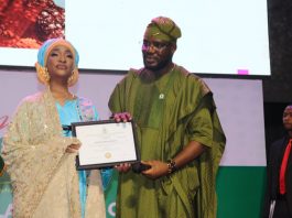 The Honourable Minister of Federal Ministry of Art, Culture Tourism and Creative Economy, Barr Musa Musawa receiving her certificate by the Director General/ Chief Executive Officer of NIHOTOUR during the induction and certification ceremony recently at Merit House, Abuja.