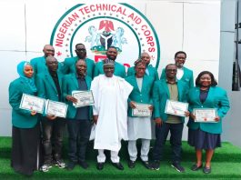 The Director-General, Nigerian Technical Aid Corps, Rt. Hon. Yusuf Buba Yakub (M) flanked by the 11 Returning Volunteers from Uganda at the Debriefing Exercise held at the NTAC Complex *25th May, 2026*