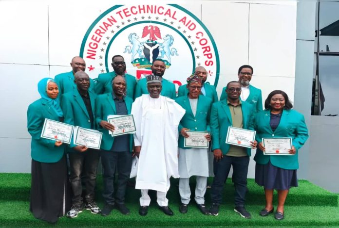 The Director-General, Nigerian Technical Aid Corps, Rt. Hon. Yusuf Buba Yakub (M) flanked by the 11 Returning Volunteers from Uganda at the Debriefing Exercise held at the NTAC Complex *25th May, 2026*