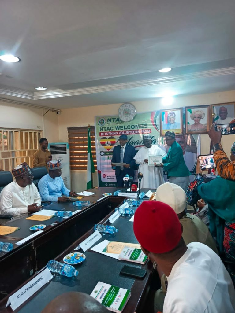 THE DG/CEO, NTAC RT.  HON. YUSUF BUBA YAKUB AND DIRECTOR PROGRAMMES AMB. BELLO A. JAYE, PRESENTING CERTIFICATE OF RETURN TO THE VOLUNTEERS' TEAM LEAD PROF. YUSUF ALI ZOAKA.