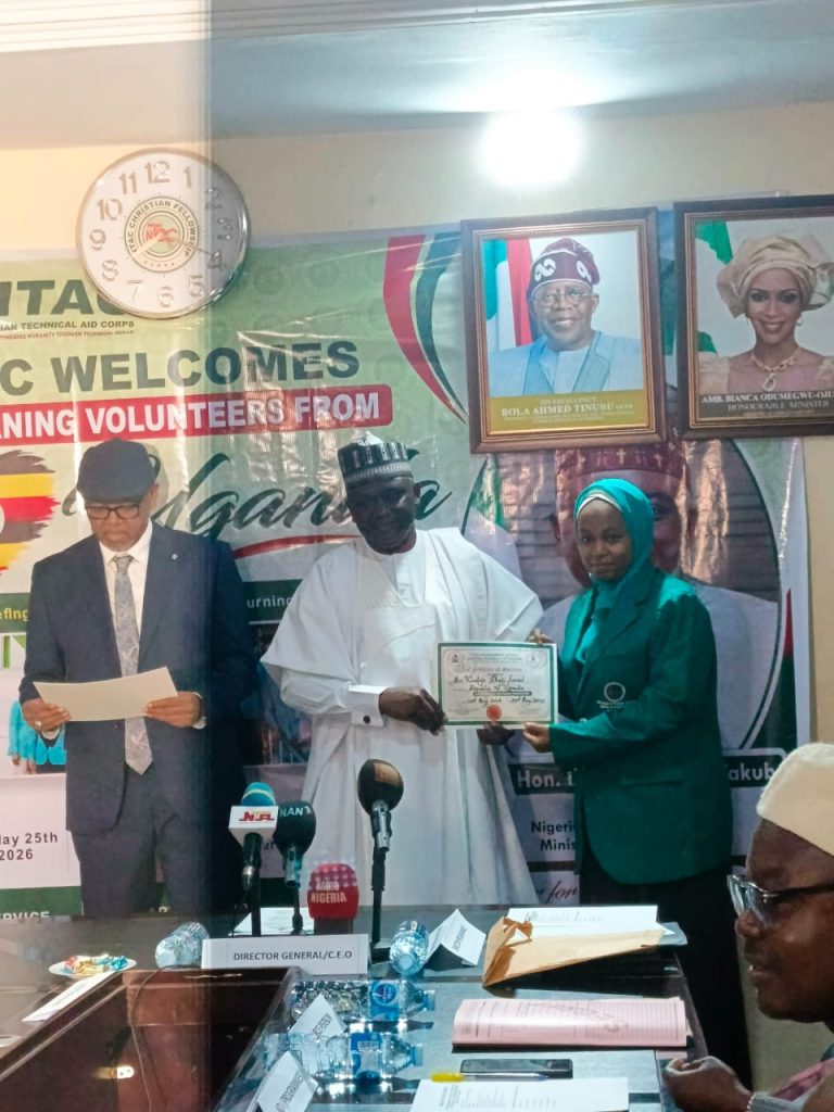The Director-General of the Nigerian Technical Aid Corps, Rt. Hon. Yusuf Buba Yakub (M), with Director of Programmes, Amb. Bello A. Jaye (R), presenting a Certificate of Return to Uganda returnee volunteer, Mrs. Khadija Alhaji Lawal (L), during the debriefing session at the NTAC Complex, Abuja.
 *May 25th 2026*