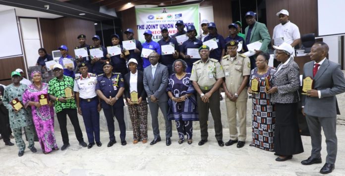 Minister of Interior, Dr. Olubunmi Tunji-Ojo (middle), Permanent Secretary of Ministry of Interior, Dr. Magdalene Ajani (6th right), with guests and awards during the maiden edition of the Ministry of Interior Innovation and Challenge Award Ceremony and joint Union Council (JUC) Week celebration in Abuja.