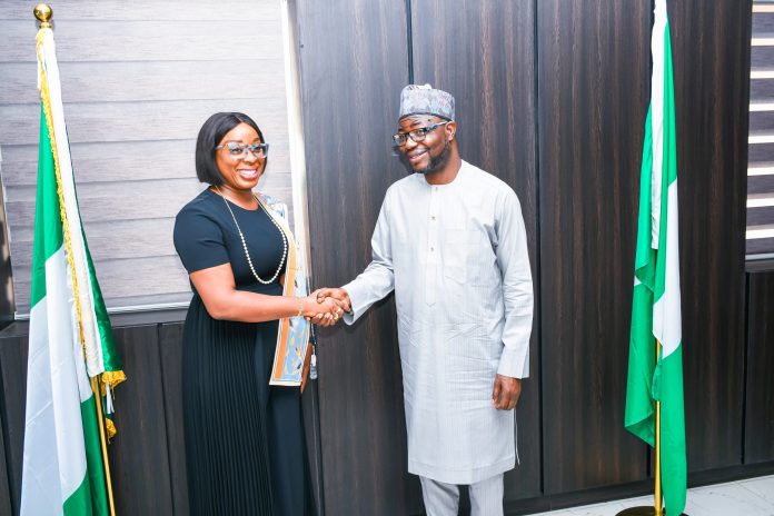 The Honourable Minister of Humanitarian Affairs and Poverty Reduction.Dr. Bernard M. Doro in a handshake with the leader of the delegation the CEO. Enhancing Financial Inclusion and Advancement (EFInA) Foyinsolami Akinjayeju during the visit.