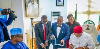 Hon. Minister of State for Health and Social Welfare Dr Iziaq Adekunle Salako watching his Excellency, Governor of Imo State Senator Hope Uzodimma signing MoU between the Health Ministry and Imo State Government for takeover and Upgrade of General Hospital Okigwe to a Federal Medical Center, Okigwe.