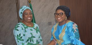 The Ag. National Coordinator/CEO of the SERVICOM Office, Mrs. Helen Lawal decorating the Director SERVICOM, Hajiya Aisha Muhammed as the Nodal Officer for NRS during the Inauguration.