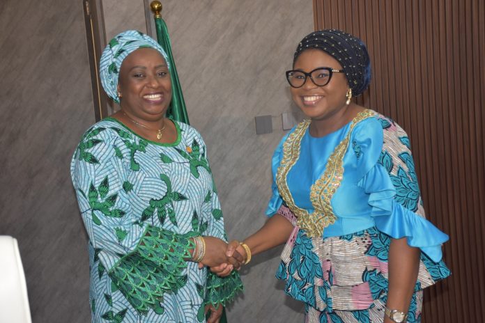 The Ag. National Coordinator/CEO of the SERVICOM Office, Mrs. Helen Lawal decorating the Director SERVICOM, Hajiya Aisha Muhammed as the Nodal Officer for NRS during the Inauguration.