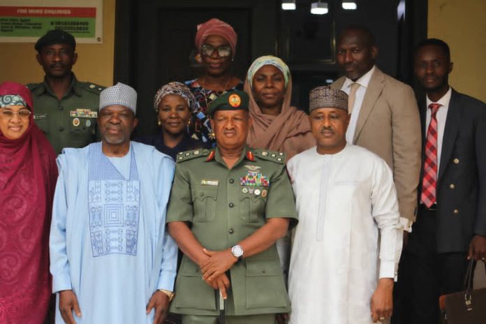 Director-General of the NBC, Surveyor Adamu Adaji, and some Directors of the Commission posed for a group photograph with Brigadier General M.B. Shehu and his team, after the meeting.