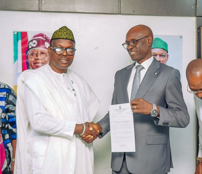 IMG-20260624-WA0183 Dr. Donald Ibe Ofili in handshake with the Honourable Minister of State for Health and Social Welfare Dr Iziaq Adekunle Salako immediately after receiving his letter of appointment