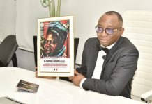Director-General, Bureau of Public Procurement (BPP) Dr. Adebowale A. Adedokun, FCIPS, displaying the award presented to him by the National President, Northern Youth Association of Nigeria at his office in Abuja