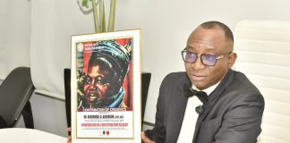Director-General, Bureau of Public Procurement (BPP) Dr. Adebowale A. Adedokun, FCIPS, displaying the award presented to him by the National President, Northern Youth Association of Nigeria at his office in Abuja