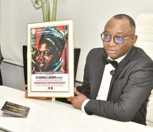 Director-General, Bureau of Public Procurement (BPP) Dr. Adebowale A. Adedokun, FCIPS, displaying the award presented to him by the National President, Northern Youth Association of Nigeria at his office in Abuja