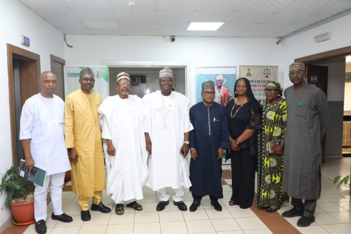 (4th left)The representative of the Secretary to the Government of the Federation and Permanent Secretary (General Services Office), Dr. Ibrahim Abubakar Kana mni flanked by the Chairman, Presidential Committee on Trade Malpractices, Malam Dahiru-Ado Kurawa (3rd left) Director (General Services) OSGF, Idris Ibrahim (4th right) along with other committee members and some Management Staff of OSGF in a group photograph during the courtesy visit in Abuja.