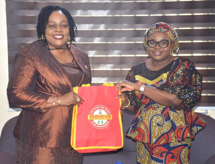 R – L, The Ag. National Coordinator/CEO of the SERVICOM Office, Mrs. Helen Lawal presenting SERVICOM awareness materials to the Registrar and Chief Executive of Teachers Registration Council of Nigeria (TRCN), Dr. (Mrs.) Ronke Soyombo during the courtesy visit to the Headquarters of the council in Abuja on 30th June, 2026.