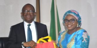L-R The Managing Director and Chief Executive of the Nigeria Deposit Insurance Corporation (NDIC), Mr. Thompson Oludare Sunday receiving some awareness materials from the Ag. National Coordinator/CEO of the SERVICOM Office, Mrs. Helen Lawal during the courtesy visit to the Head Office of the NDIC on 7th July, 2026.