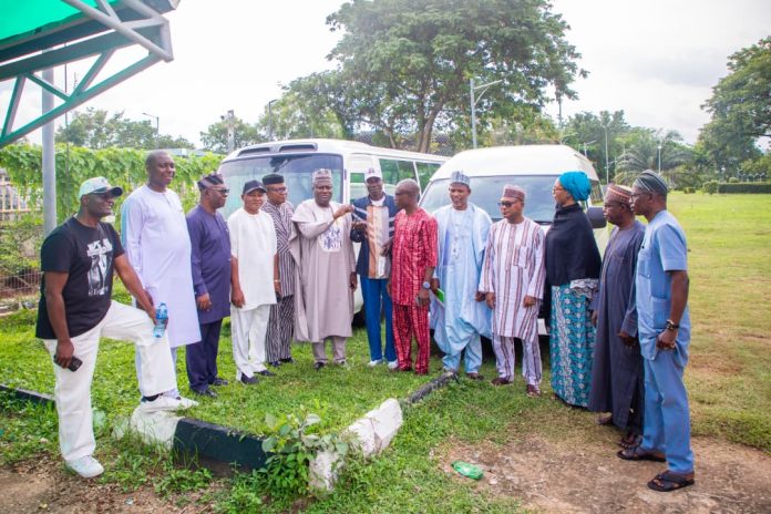 Representative of the Secretary to the Government of the Federation and Permanent Secretary (General Services Office), Dr. Ibrahim Abubakar Kana, mni, (6th left) flanked by some Management Staff of OSGF and Benue State APC Stakeholders as he handes over the keys of the two buses donated by SGF, Sen. George Akume CON to the Chairman of Joint Council of Unions in the Office of the Secretary to the Government of the Federation, Comrade Paul Idowu on Friday, 10th July, 2026 in Abuja.