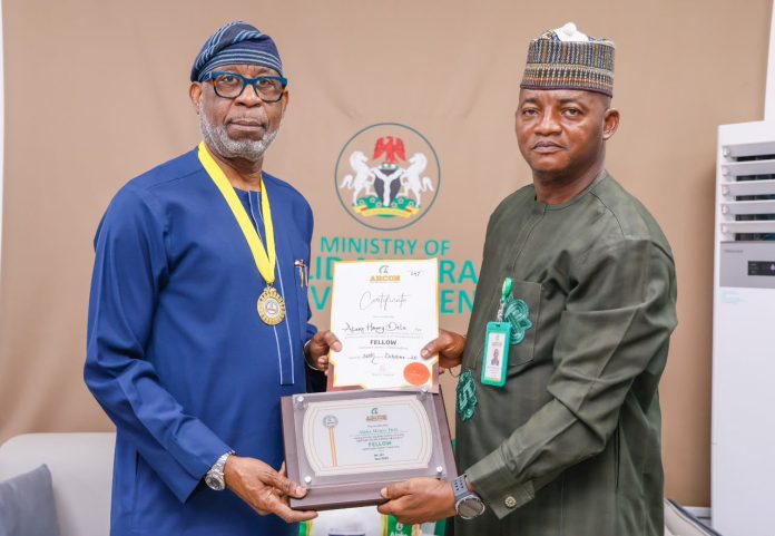 IMG-20260715-WA0384(1) Minister of Solid Minerals Development, Dele Alake (left), and the Director-General of the Advertising Regulatory Council of Nigeria (ARCON), Dr. Olalekan Fadolapo, during the conferment of an Honorary Fellowship by ARCON on the Minister at the Ministry of Solid Minerals Development headquarters in Abuja on July 15, 2026.