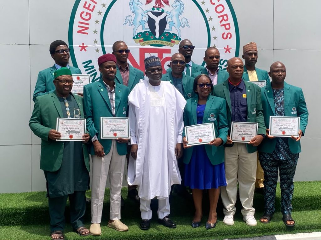 Director-General/Chief Executive Officer of the Nigerian Technical Aid Corps (NTAC), Rt. Hon. Yusuf Buba Yakub, in a group photograph with the 11 Returning NTAC Volunteers from The Gambia following their Debriefing Session, held on Monday, 20th July, 2026, at the NTAC Complex, Abuja.