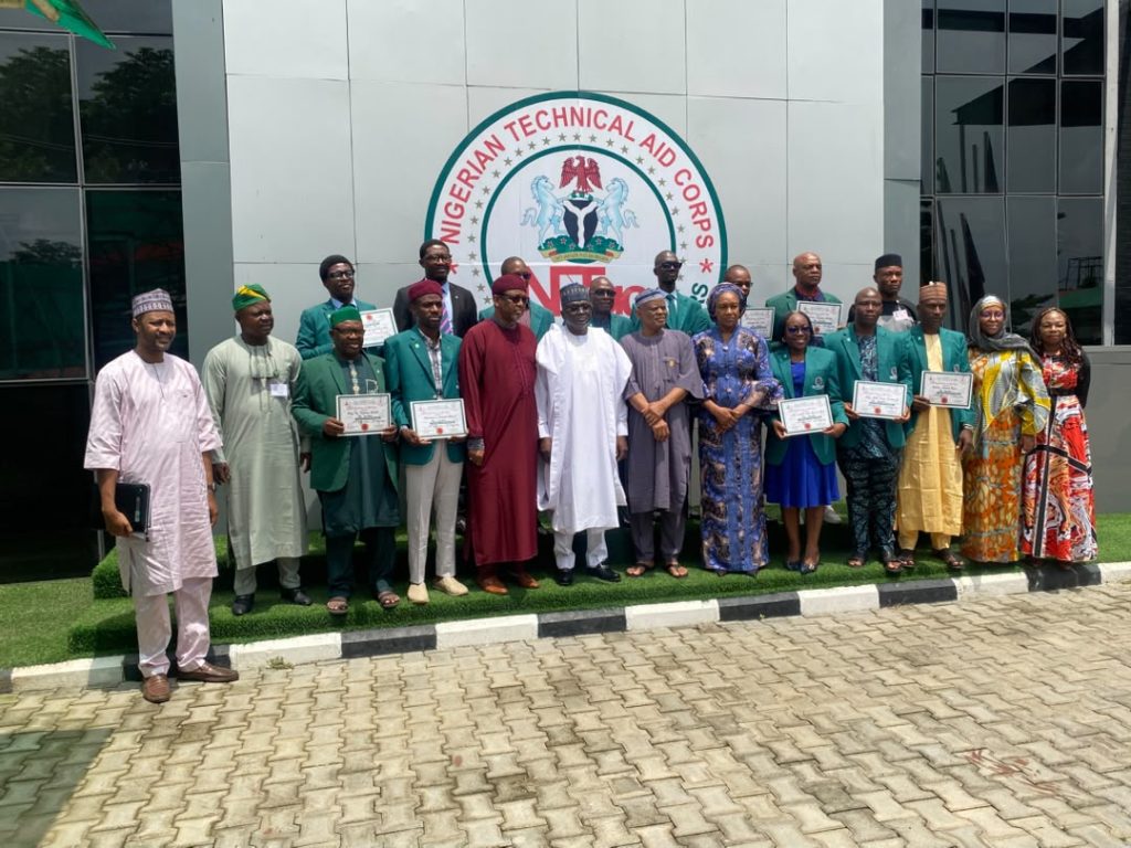 Director-General/Chief Executive Officer of the Nigerian Technical Aid Corps (NTAC), Rt. Hon. Yusuf Buba Yakub (6th from right), flanked by Directors and other staff members of the Corps, in a group photograph with the 11 Returning NTAC Volunteers from The Gambia following their Debriefing Session, held on Monday, 20th July, 2026, at the NTAC Complex, Abuja.