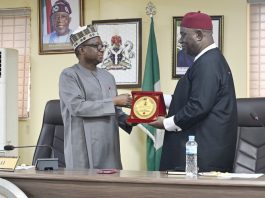 L–R: RMAFC Chairman, Dr. Mohammed Bello Shehu, OFR, presents a souvenir to the Vice Chancellor of the National Open University of Nigeria (NOUN), Dr Oduma Orji Oduma, during the courtesy visit to the Commission.
