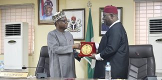 L–R: RMAFC Chairman, Dr. Mohammed Bello Shehu, OFR, presents a souvenir to the Vice Chancellor of the National Open University of Nigeria (NOUN), Dr Oduma Orji Oduma, during the courtesy visit to the Commission.