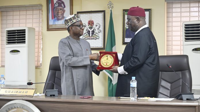L–R: RMAFC Chairman, Dr. Mohammed Bello Shehu, OFR, presents a souvenir to the Vice Chancellor of the National Open University of Nigeria (NOUN), Dr Oduma Orji Oduma, during the courtesy visit to the Commission.