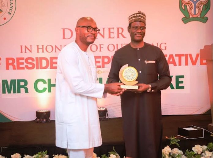 Outgoing IMF Resident Representative R–L: Honourable Minister of Finance and Coordinating Minister of the Economy, Mr. Taiwo Oyedele, presents a commemorative plaque to the outgoing International Monetary Fund (IMF) Resident Representative to Nigeria, Dr. Christian Ebeke, during a dinner held in his honour.