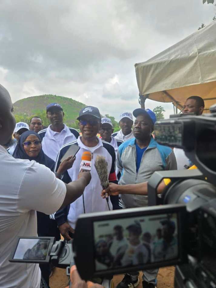 Representative of the Head of the Civil Service of the Federation, Dr. Garba Abdul (centre), flanked on his left by the Permanent Secretary, Federal Ministry of Labour and Employment, Dr. Kamil Shoretire, and on his right by the Permanent Secretary, Federal Ministry of Marine and Blue Economy, Mrs. Fatima Mahmoud, while addressing journalists during the Monthly Keep-Fit Exercise for Federal Ministries, Departments and Agencies (MDAs) at the Moshood Abiola National Stadium, Abuja, on Saturday, July 25, 2026.