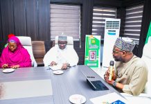 R:- The Honourable Minister of Humanitarian Affairs and Poverty Reduction. Dr. Bernard M Doro responds to the Registrar, Pharmacy Council of Nigeriaby his left in white, Pharmacist Ibrahim Baba Shehu Ahmed when the team from the council visited him in his office in Abuja.