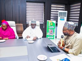 R:- The Honourable Minister of Humanitarian Affairs and Poverty Reduction. Dr. Bernard M Doro responds to the Registrar, Pharmacy Council of Nigeriaby his left in white, Pharmacist Ibrahim Baba Shehu Ahmed when the team from the council visited him in his office in Abuja.