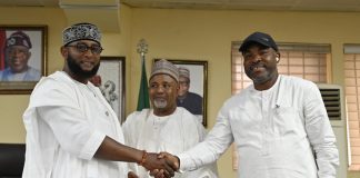 L-R: Outgoing RMAFC Secretary, Engr. Joseph Okechukwu Nwaze in a handshake with incoming RMAFC Secretary, Comrade Tosin Adeyanju as Federal Commissioner, as Kabir Mohammad Mashi Federal Commissioner, Katsina (Middle) watches on