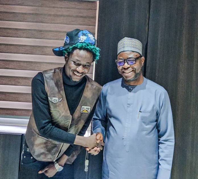 R- L : the Honourable Minister of Humanitarian Affairs and Poverty Reduction. Dr. Bernard M Doro in a handshake with the star IDP young man. OG Abbah when the delegation from IFON Youth Initiative visited the Minister in his office.