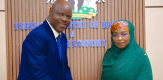 The Permanent Secretary, Federal Ministry of Marine and Blue Economy, Mrs. Fatima Sugra Tabi’a Mahmood (right), receives a brochure highlighting the range of services offered by Coronation Group Limited from the company's Director, Government and Federal Capital, Mr. David Aluko, after a courtesy visit to the Ministry's in Abuja.