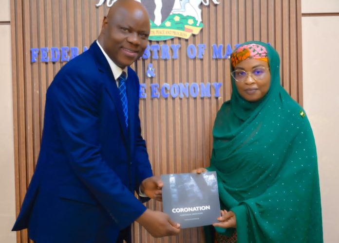 The Permanent Secretary, Federal Ministry of Marine and Blue Economy, Mrs. Fatima Sugra Tabi’a Mahmood (right), receives a brochure highlighting the range of services offered by Coronation Group Limited from the company's Director, Government and Federal Capital, Mr. David Aluko, after a courtesy visit to the Ministry's in Abuja.