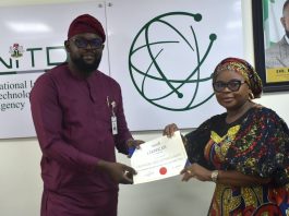 The Ag. National Coordinator/CEO of the SERVICOM Office, Mrs. Helen Lawal presenting ISO 9001 Lead Auditors Certificate to one of the successful members of staff, Oluwole Adegboyega Alao from the Corporate Communications and Media Relations Department during the Annual SERVICOM Parastatal Committee Workshop held on 24th August, 2026 at NITDA Headquarters in Abuja with the theme “Every Role Matters - Delivering Quality Service Together,”