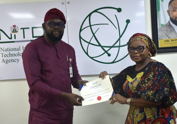 IMG-20260825-WA0158 The Ag. National Coordinator/CEO of the SERVICOM Office, Mrs. Helen Lawal presenting ISO 9001 Lead Auditors Certificate to one of the successful members of staff, Oluwole Adegboyega Alao from the Corporate Communications and Media Relations Department during the Annual SERVICOM Parastatal Committee Workshop held on 24th August, 2026 at NITDA Headquarters in Abuja with the theme “Every Role Matters - Delivering Quality Service Together,”
